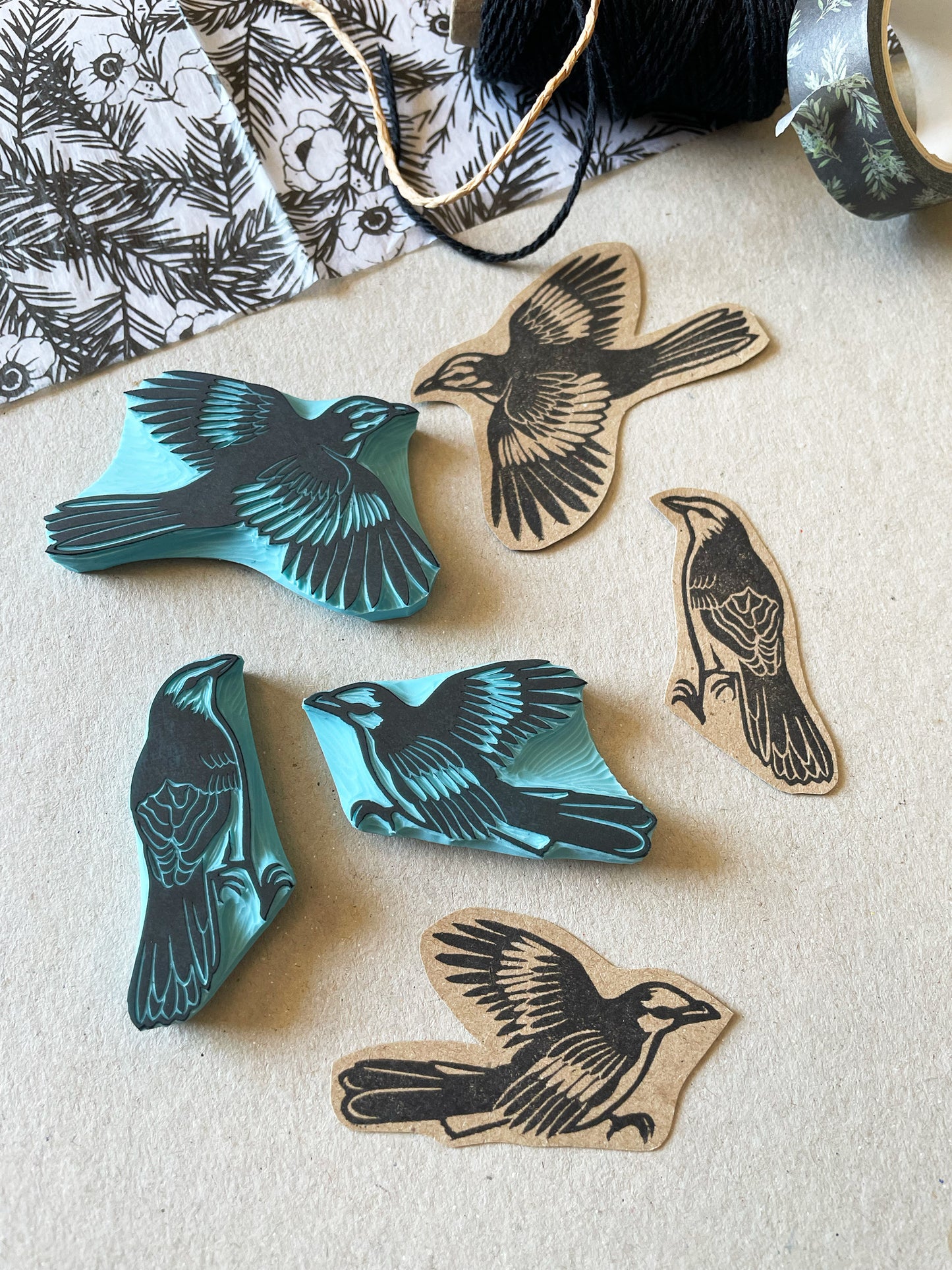 three mockingbird stamps designs on a desk with scrapbooking supplies around
