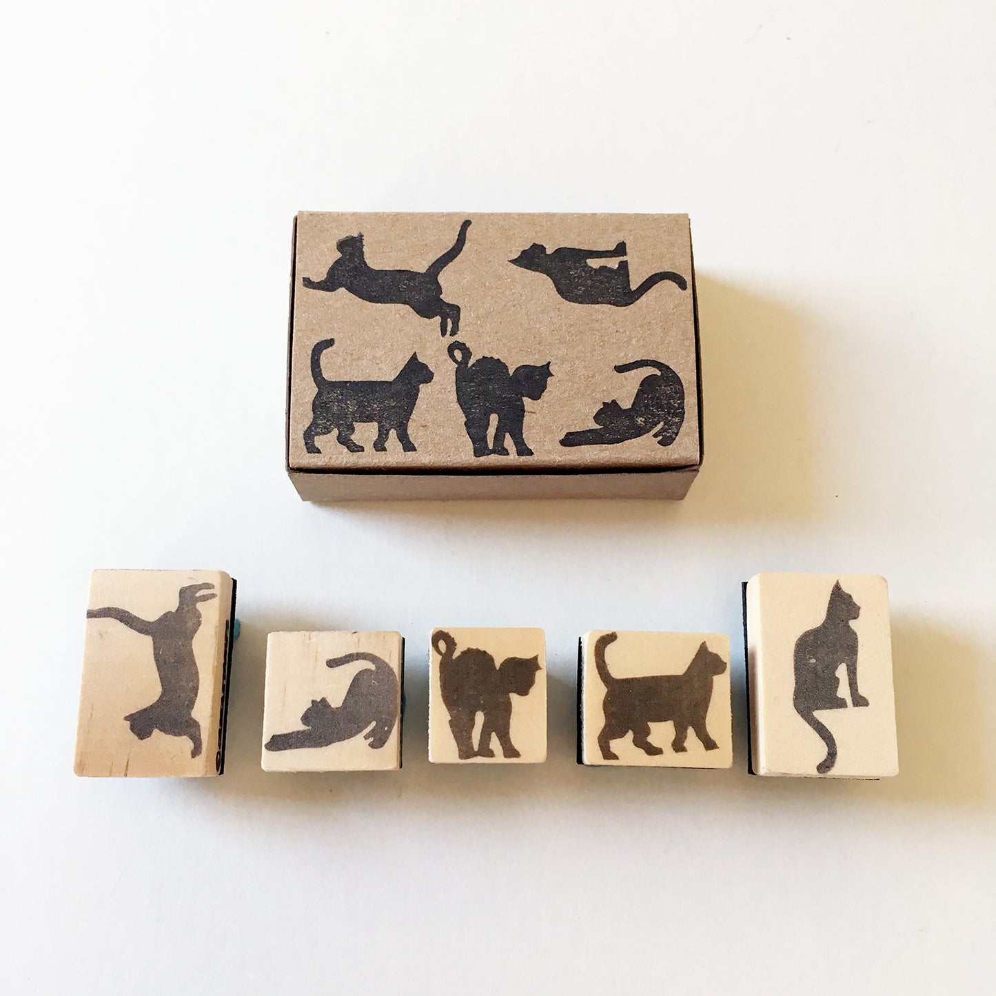 5 mini rubber stamps of cat silhouettes facing down showing the wooden bases