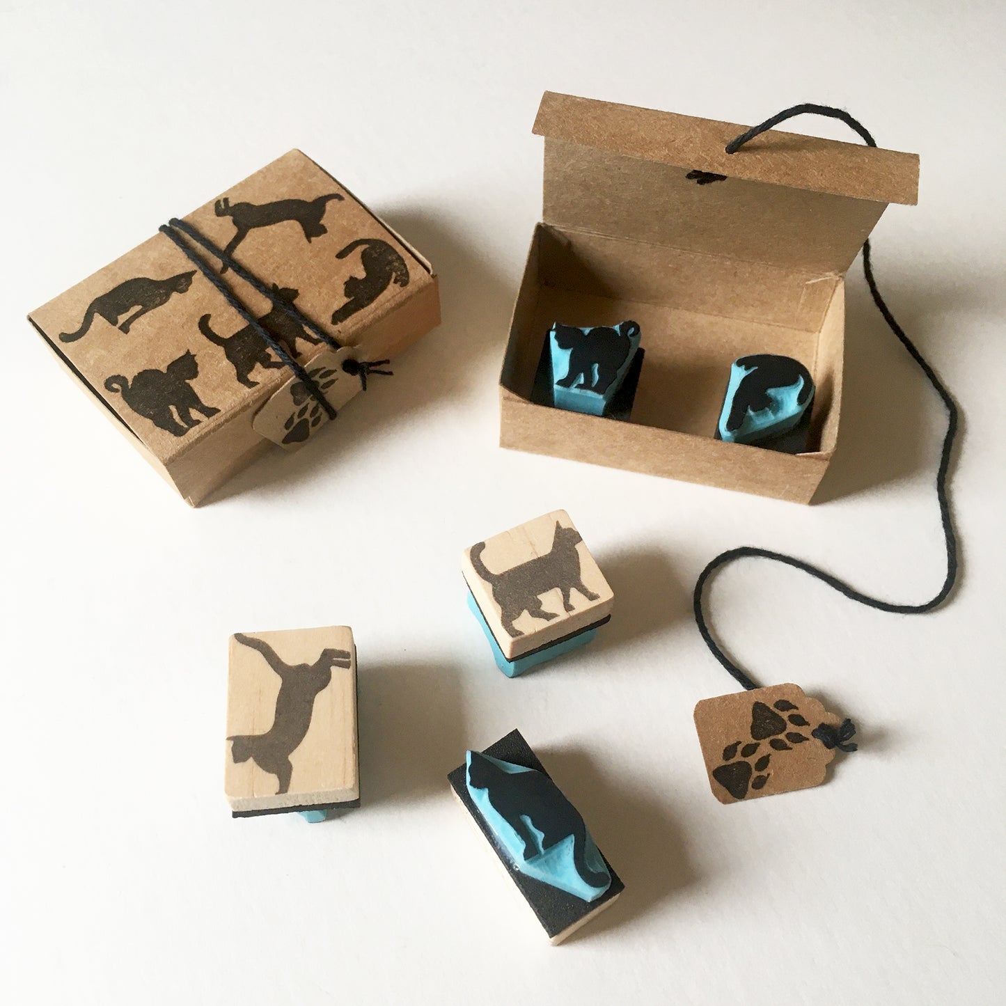 Two mini sets of cat stamps inside a cardboard box