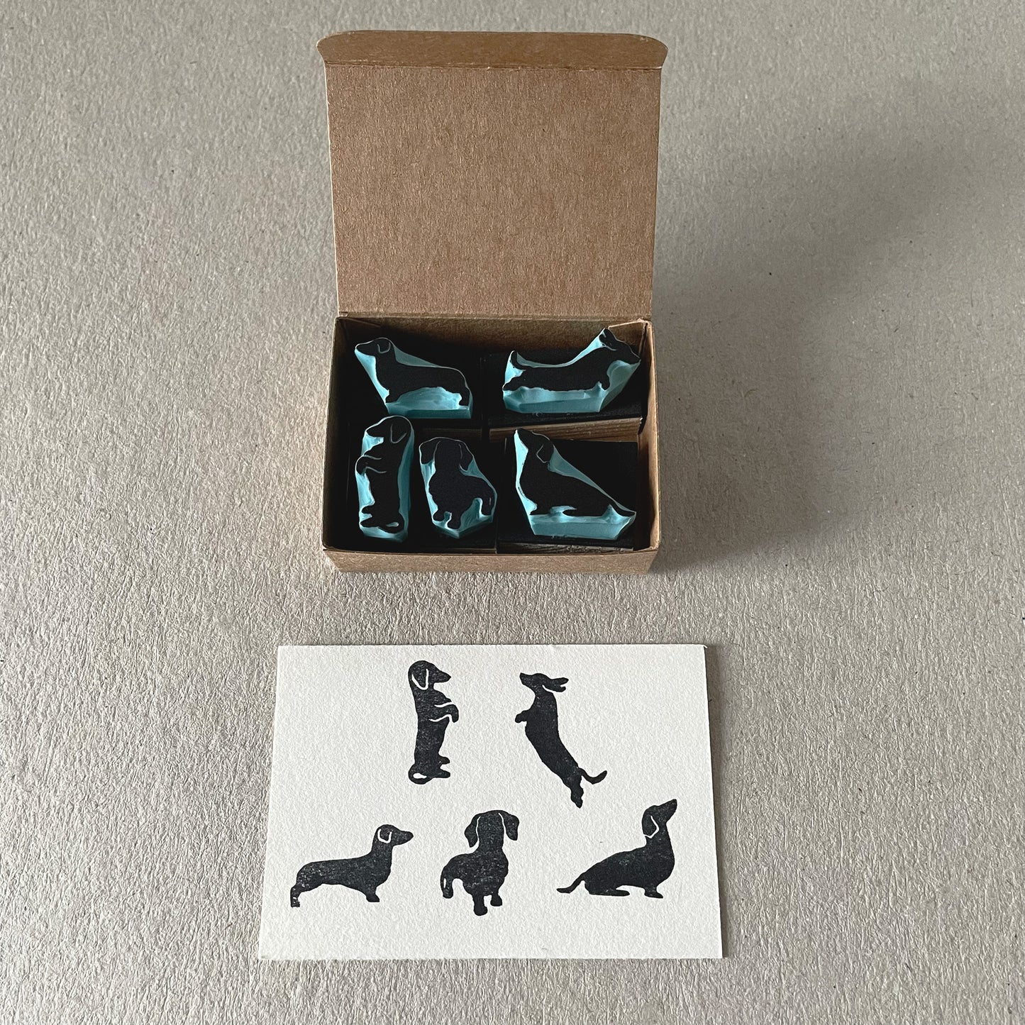 Handmade dachshund craft stamp set with tiny dog designs for stationery and scrapbooking.