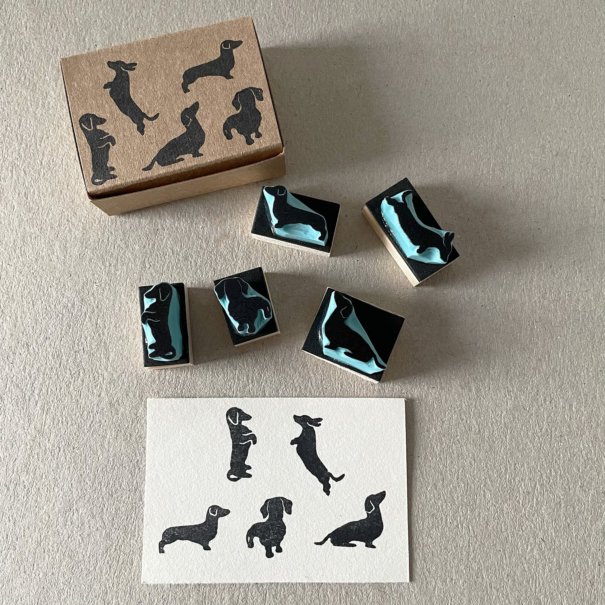 Mini sausage dog stamp set for journaling and packaging with stamped dachshund pattern.