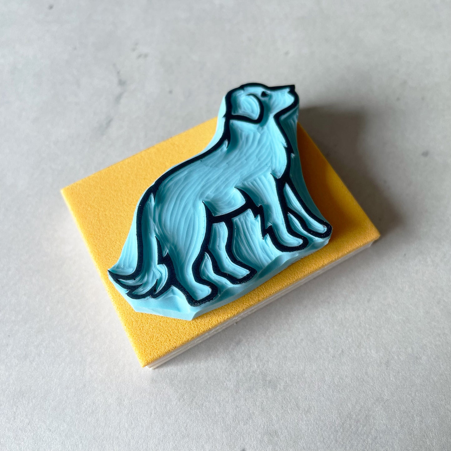 same rubber of a labrador dog image with wood base