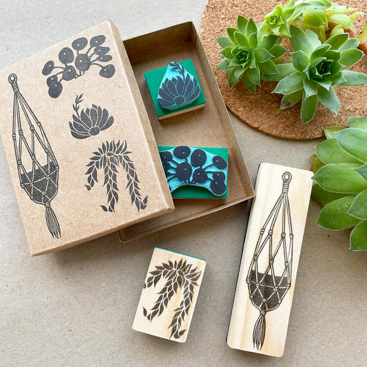 Hand carved rubber stamp set with botanical plants and macrame hanger used for journaling and packaging.