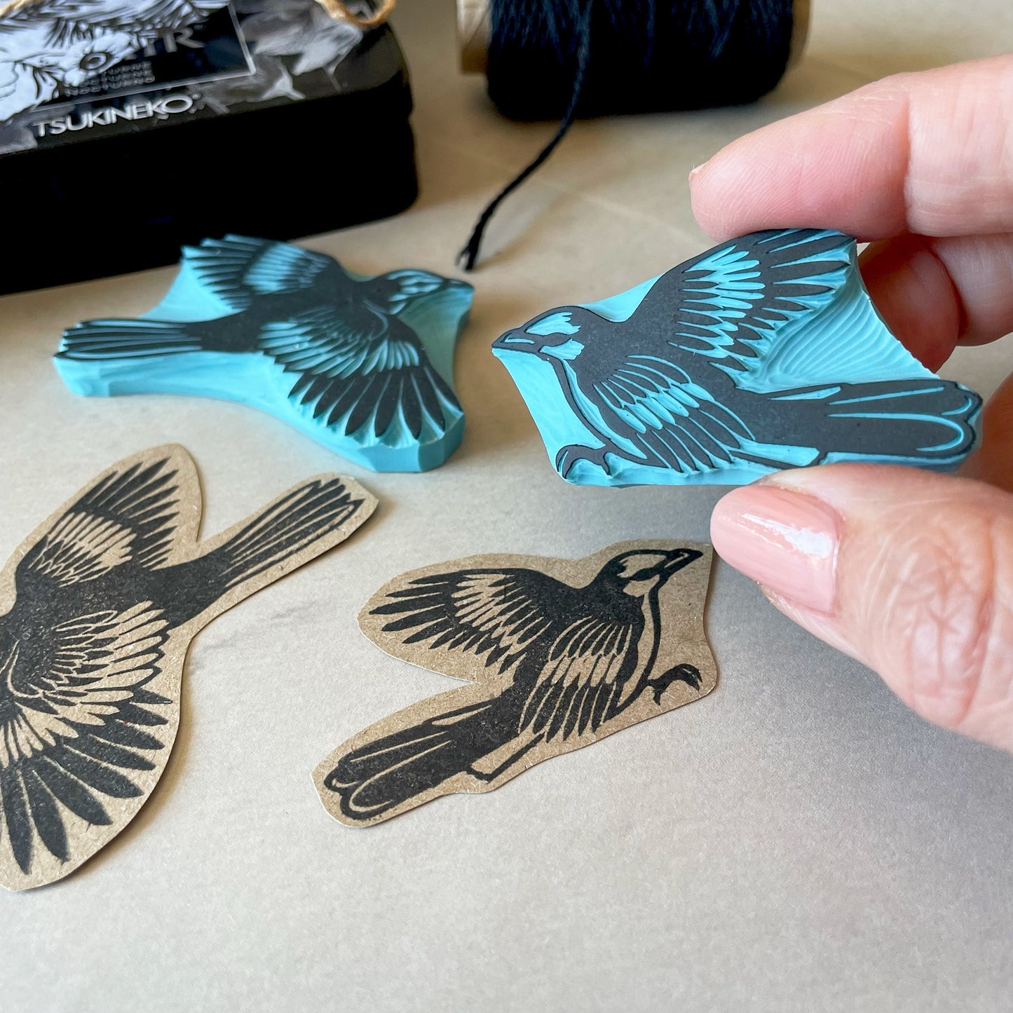 a bird rubber stamp held by hand