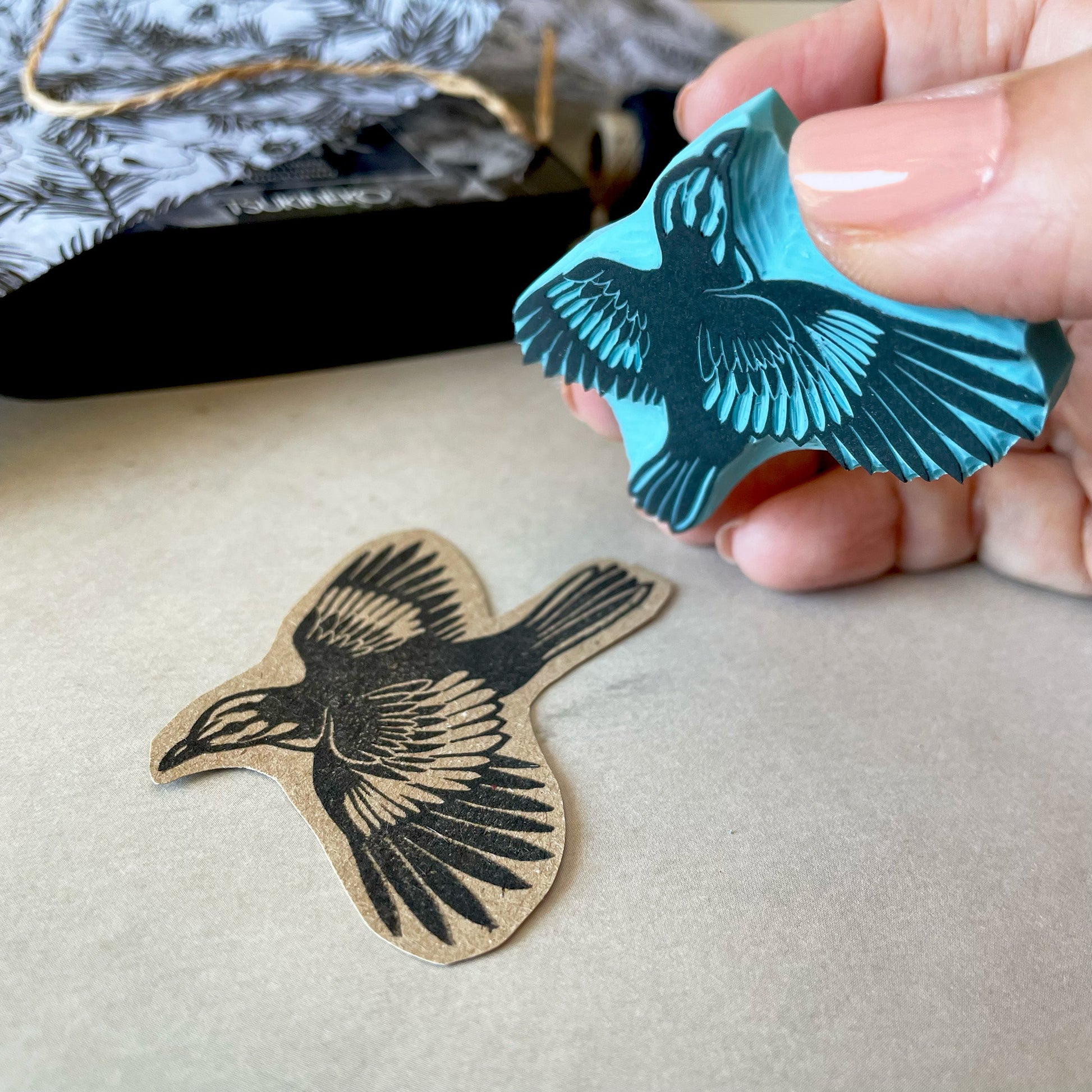 holding by hand a flying mockingbird rubber stamp