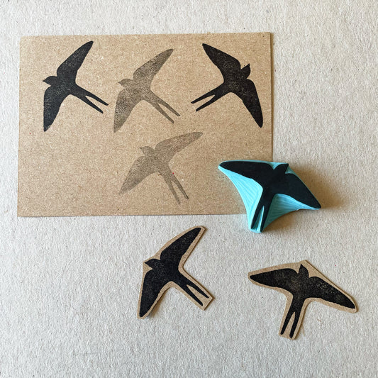 Swallow bird silhouette rubber stamp printed on a cardboard sheet 