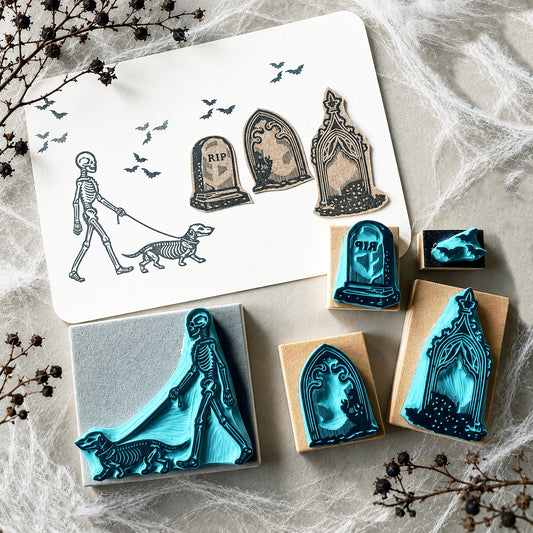 Skeleton walking a dog rubber stamps on a graveyard for Halloween spooky-cute stamping
