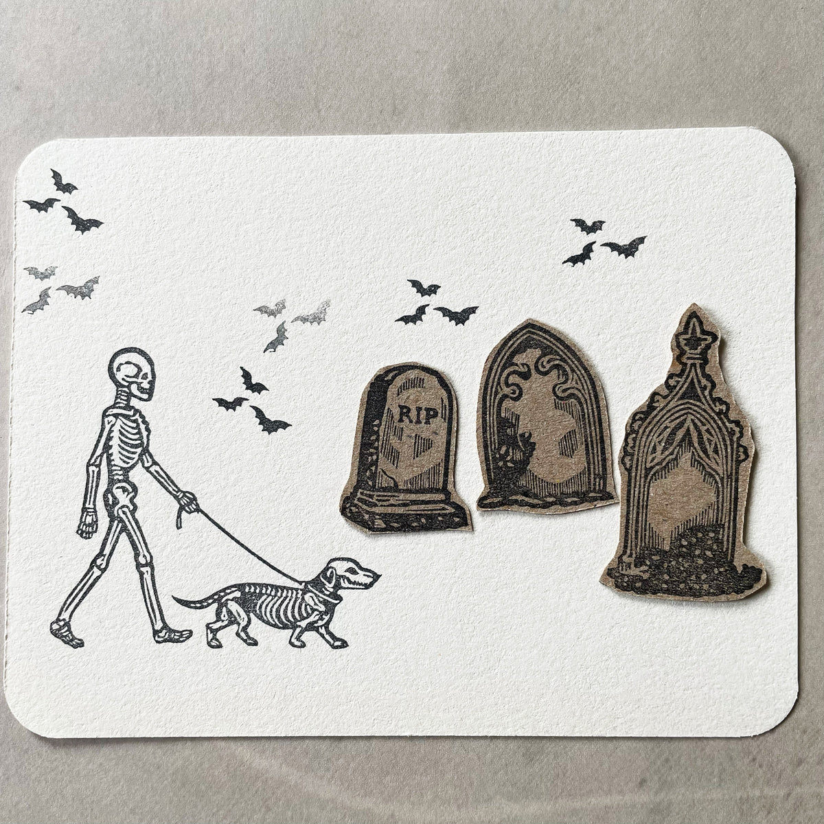 Skeleton walking a dog rubber stamps on a graveyard for Halloween spooky-cute stamping