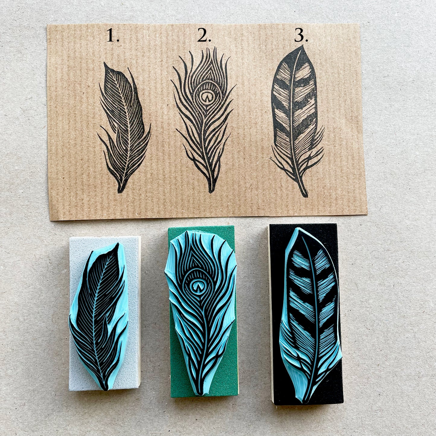 Set of three hand carved feather rubber stamps with detailed line designs, printed on kraft paper with design number, boho style craft stamps.