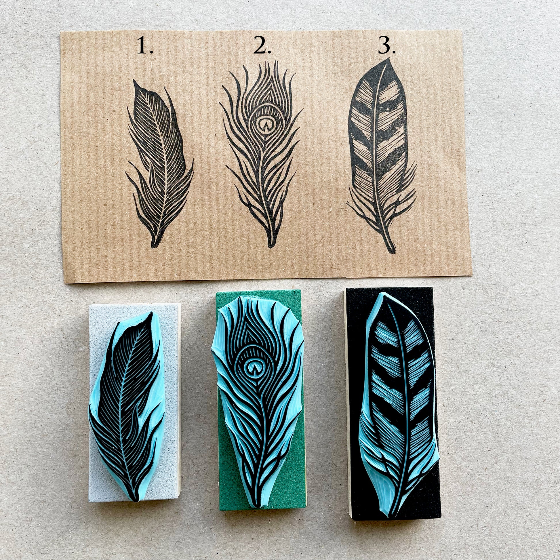 Set of three hand carved feather rubber stamps with detailed line designs, printed on kraft paper with design number, boho style craft stamps.